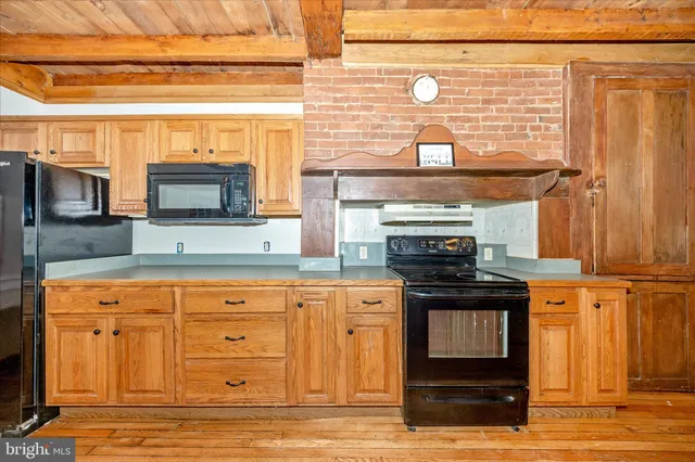 an empty room with windows and a fireplace