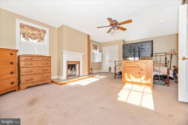 a bed room with a bed mirror and a desk