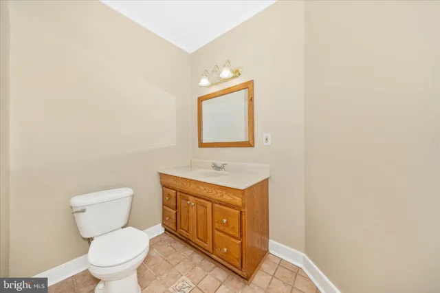 an empty room with a chandelier fan