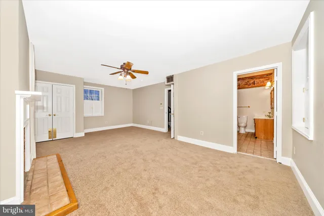 an empty room with a chandelier fan