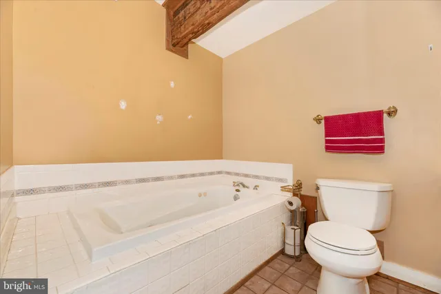 a bedroom with a bed and a chandelier fan