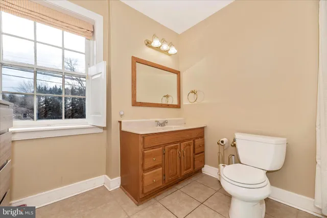 a view of a livingroom with wooden floor and furniture