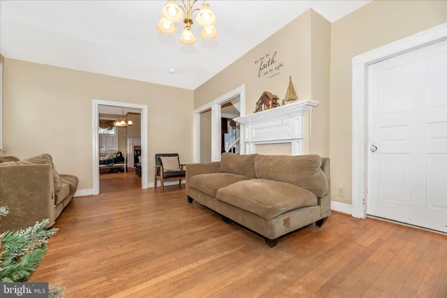 a living room with furniture and a chandelier