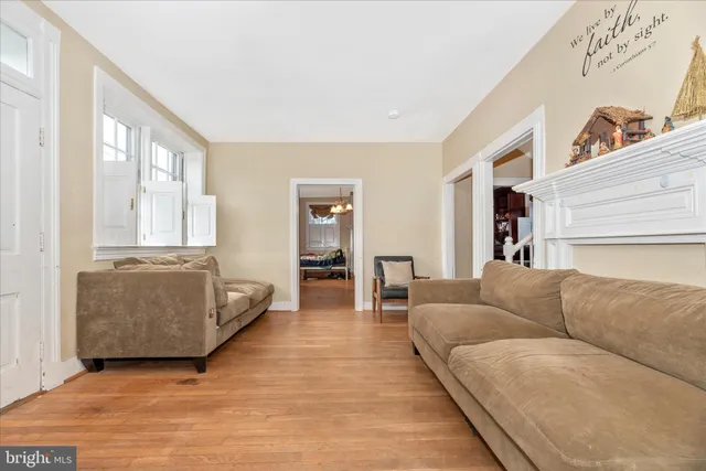 a living room with furniture and large windows