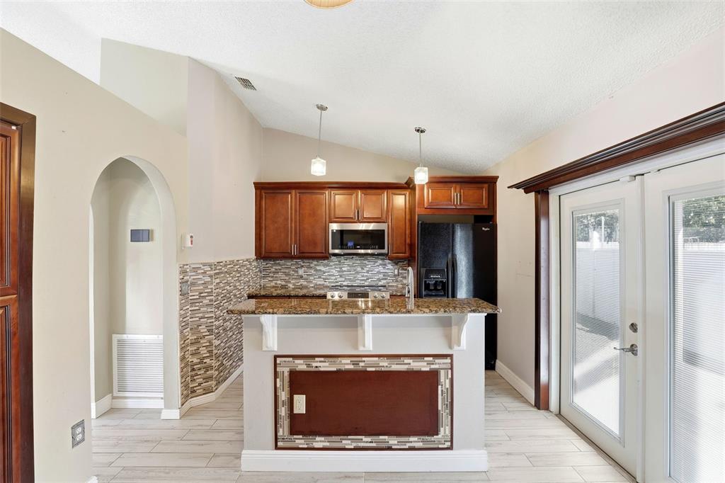10517 Rocking A Run Orlando, FL 32825 - Photo 14 of 29 a view of a kitchen with a sink and a fireplace