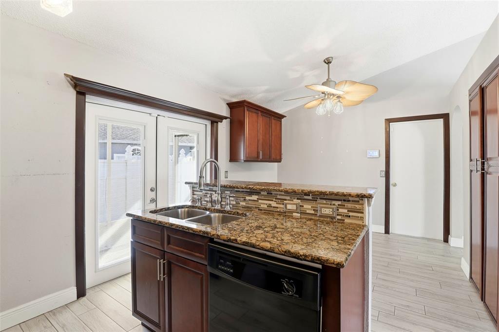 10517 Rocking A Run Orlando, FL 32825 - Photo 16 of 29 a kitchen with a counter space and a refrigerator