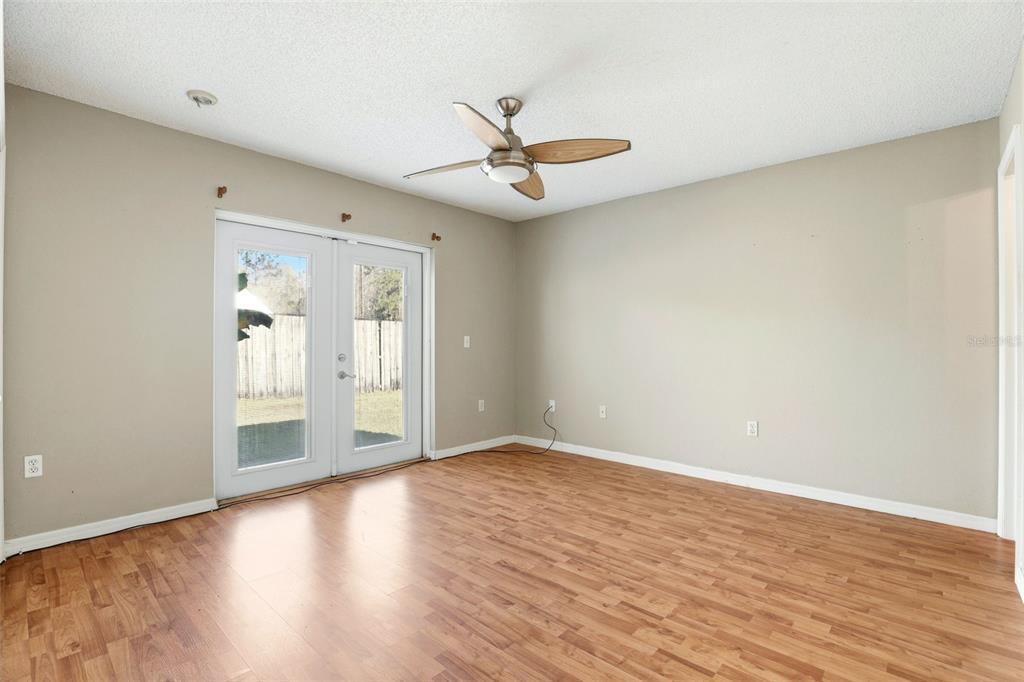 10517 Rocking A Run Orlando, FL 32825 - Photo 18 of 29 a view of an empty room with wooden floor and a window