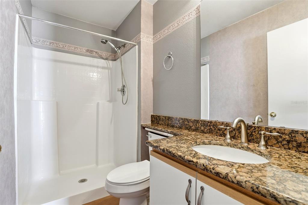 10517 Rocking A Run Orlando, FL 32825 - Photo 20 of 29 a bathroom with a granite countertop sink toilet and shower