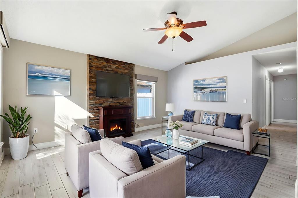 10517 Rocking A Run Orlando, FL 32825 - Photo 2 of 29 a living room with furniture a fireplace and a flat screen tv