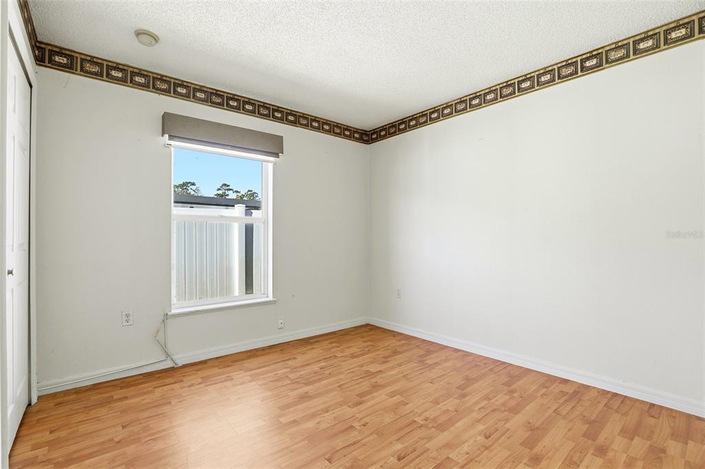 10517 Rocking A Run Orlando, FL 32825 - Photo 21 of 29 a view of empty room with window and wooden floor