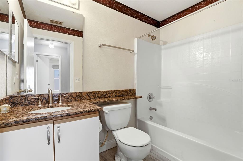 10517 Rocking A Run Orlando, FL 32825 - Photo 23 of 29 a bathroom with a granite countertop sink toilet mirror vanity and shower