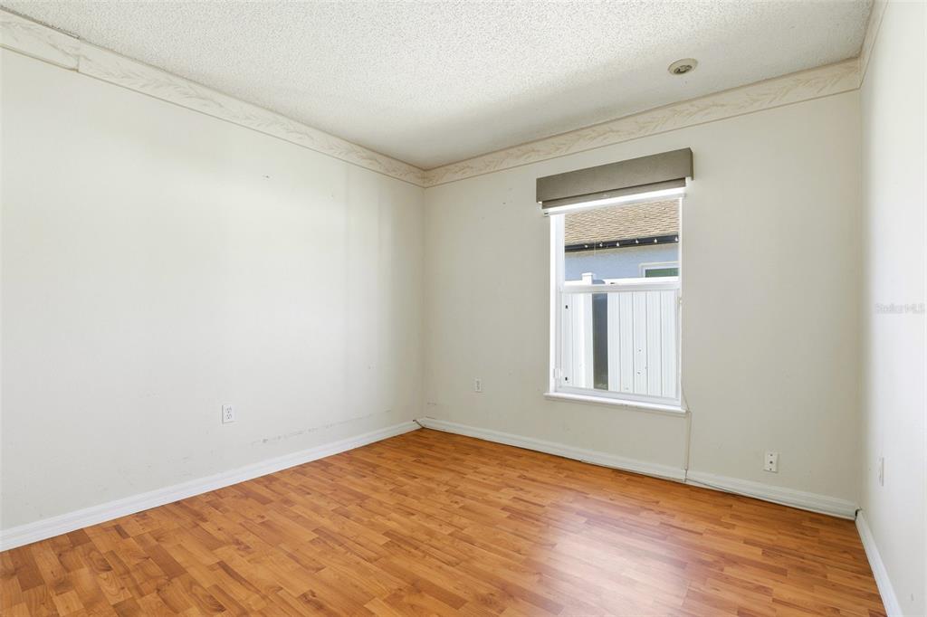 10517 Rocking A Run Orlando, FL 32825 - Photo 24 of 29 an empty room with wooden floor and windows