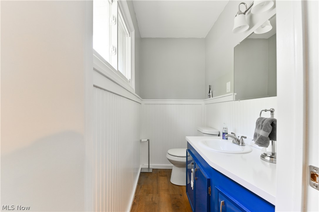 2725 Rockefeller Road Willoughby Hills, OH 44092 - Photo 13 of 21 Bathroom featuring vanity with extensive cabinet space, hardwood / wood-style flooring, and toilet
