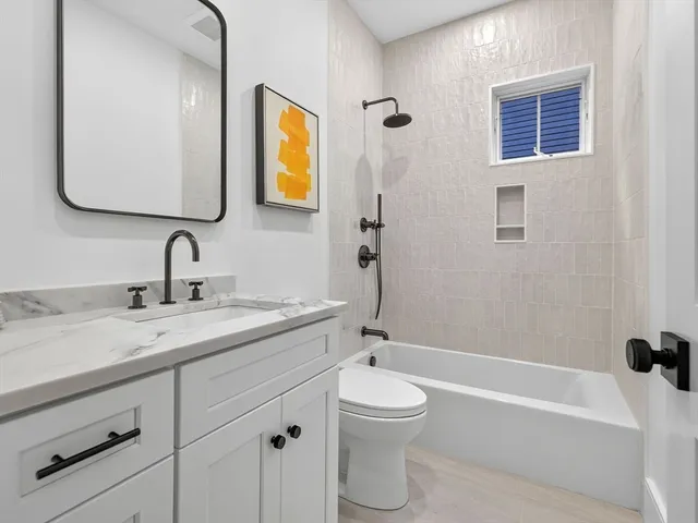 a bathroom with a toilet sink and bathtub
