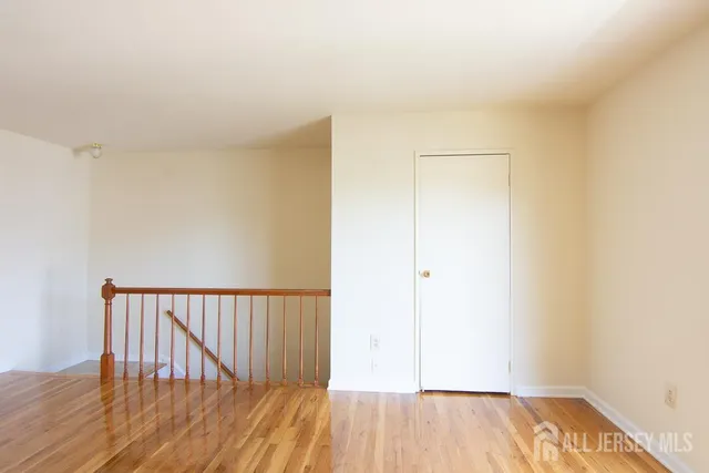 a view of hallway with wooden floor