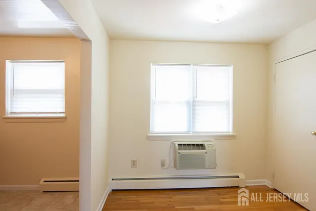 a view of a kitchen with wooden floor and cabinet