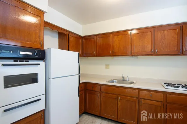 a kitchen with stainless steel appliances granite countertop a refrigerator sink and cabinets