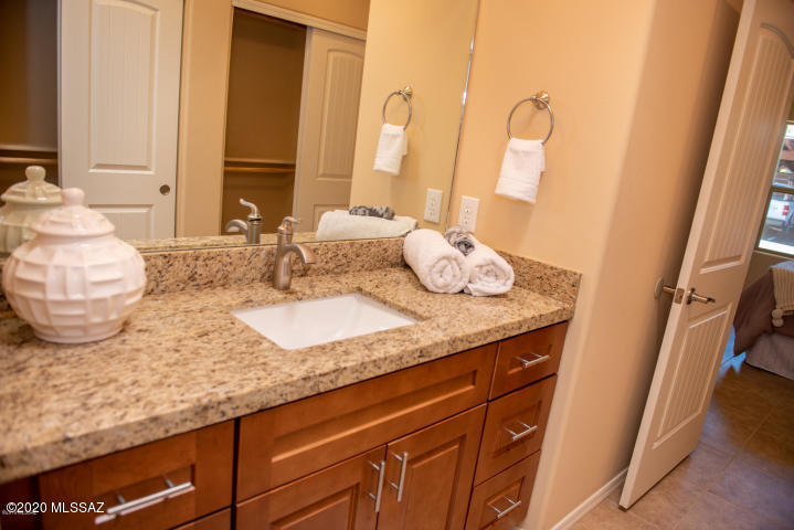 1608 Golden Gate Way Tubac, AZ 85646 - Photo 2 of 7 a bathroom with a granite countertop sink and a mirror