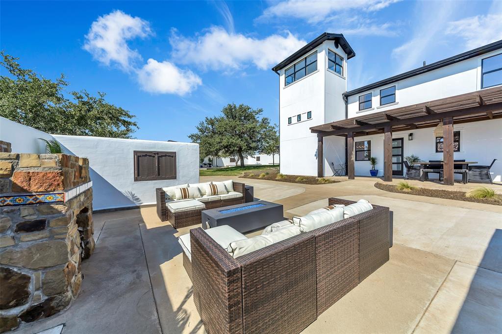 View of patio with a pergola and an outdoor living space with a fire pit