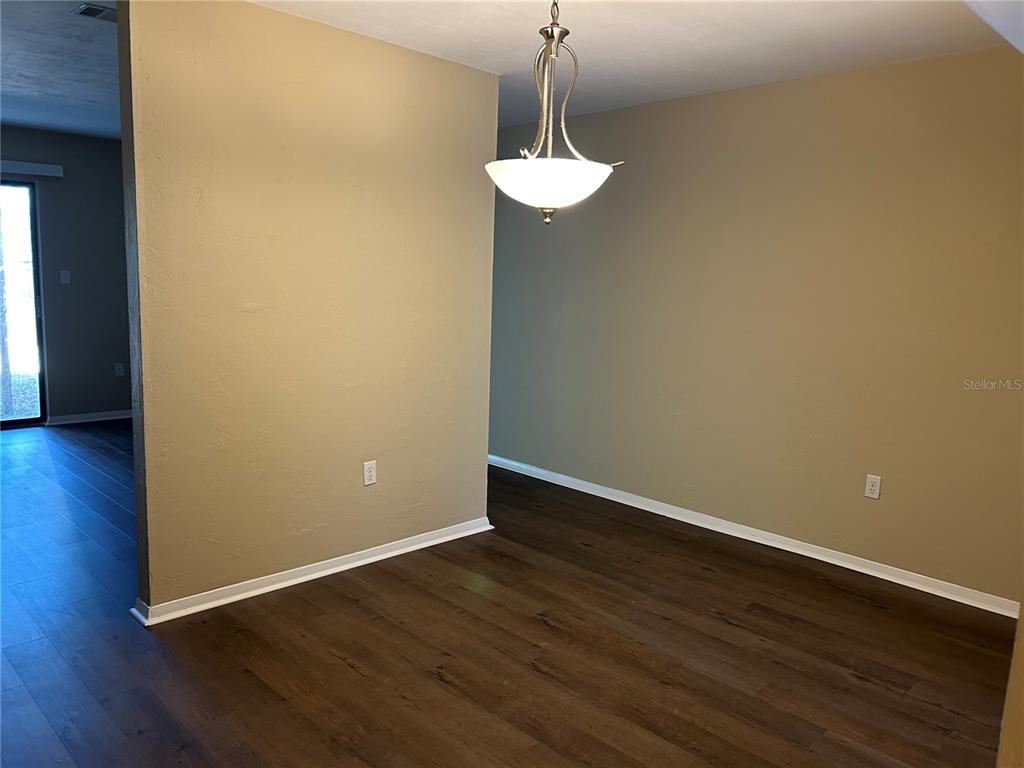 507 Northwest 39th Road, Unit 310 Gainesville, FL 32607 - Photo 6 of 18 a view of a room with wooden floor and a ceiling fan