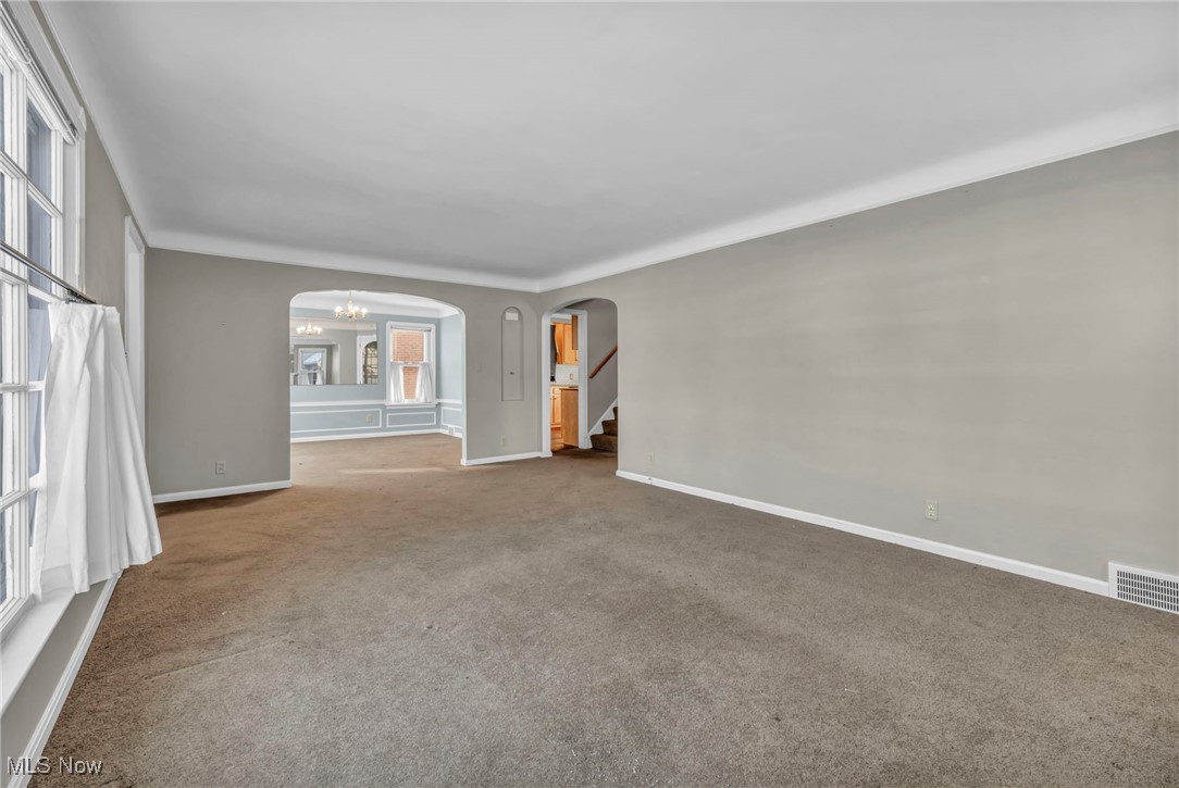 1688 Rushton Road Cleveland, OH 44121 - Photo 6 of 39 Unfurnished room featuring carpet floors and an inviting chandelier
