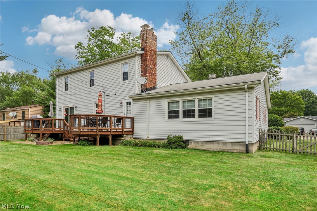 1762 Stonehaven Road Madison, OH 44057 - Photo 28 of 36 Back of property with a lawn and a wooden deck
