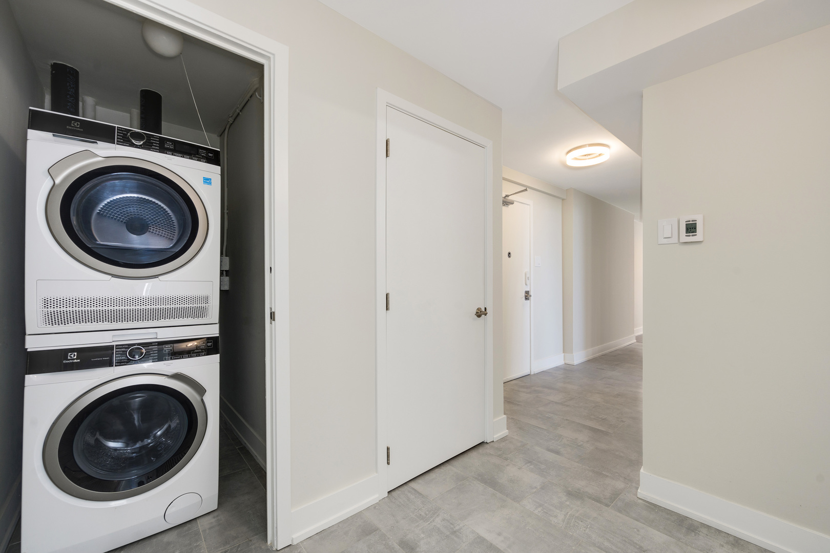 227 East Walton Place, Unit 3W Chicago, IL 60611 - Photo 12 of 15 a view of a hallway with washer and dryer