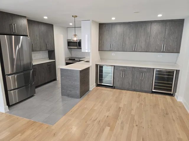 a kitchen with stainless steel appliances a refrigerator and a sink