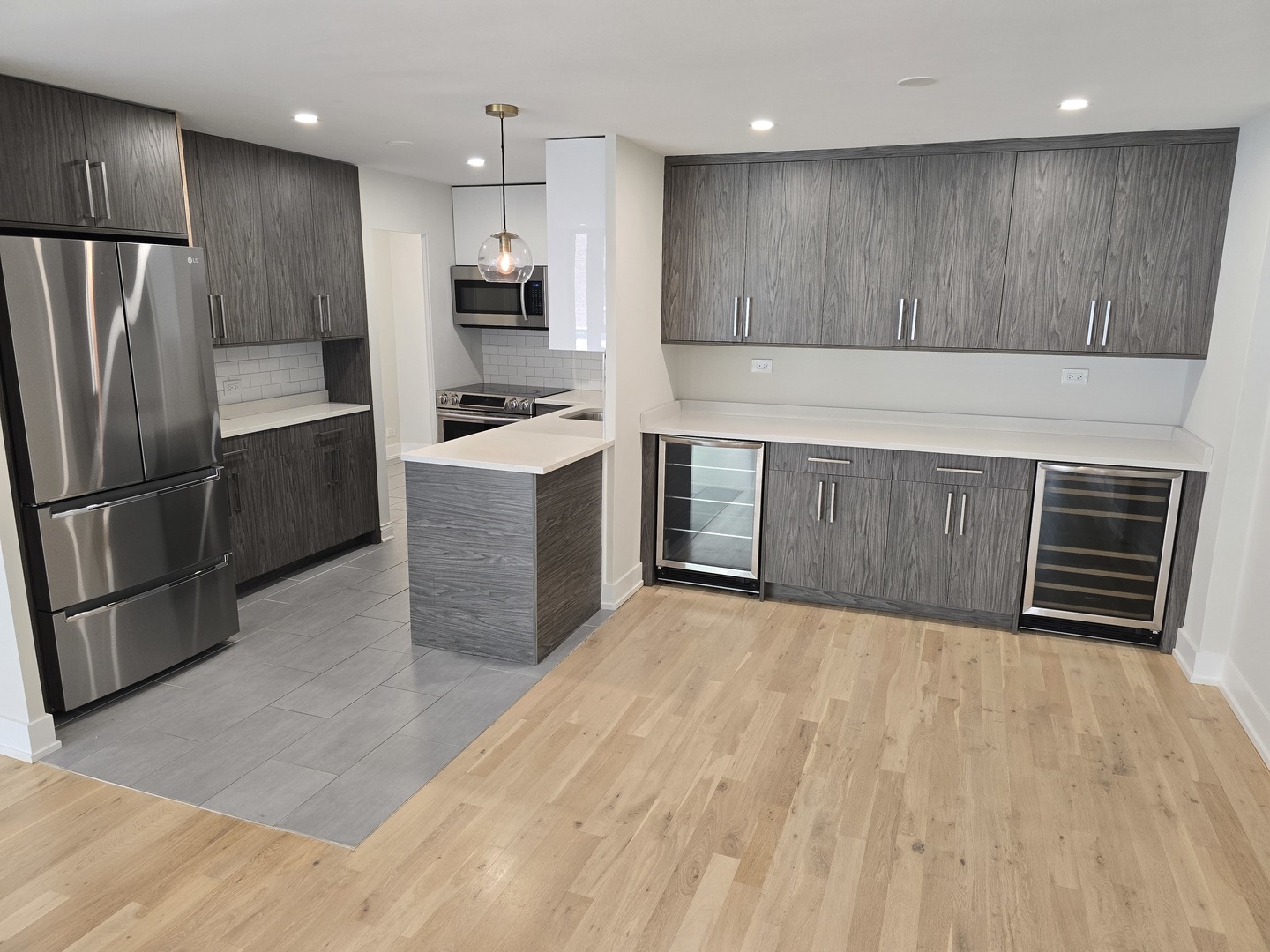 227 East Walton Place, Unit 3W Chicago, IL 60611 - Photo 2 of 15 a kitchen with stainless steel appliances a refrigerator and a sink