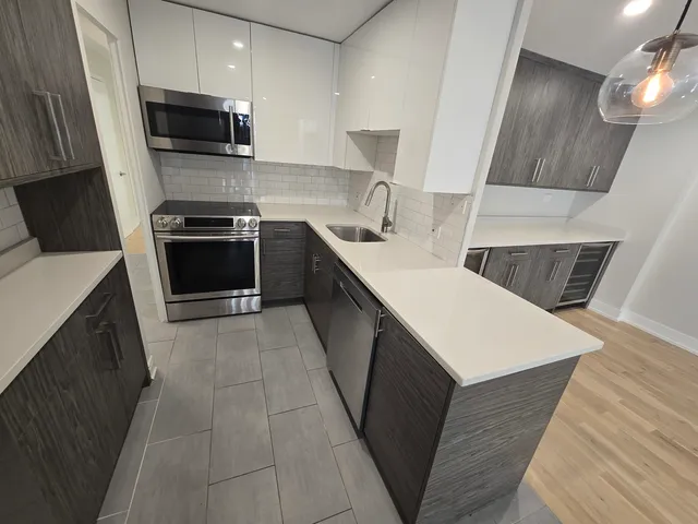 a kitchen with a sink stove and microwave