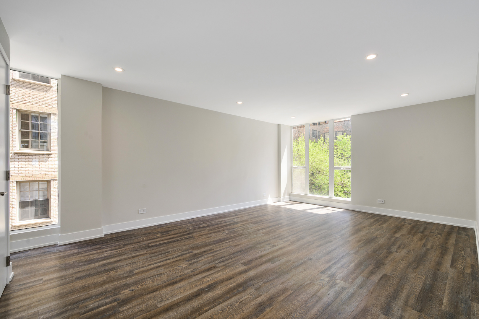 227 East Walton Place, Unit 3W Chicago, IL 60611 - Photo 8 of 15 a view of an empty room with wooden floor and a window