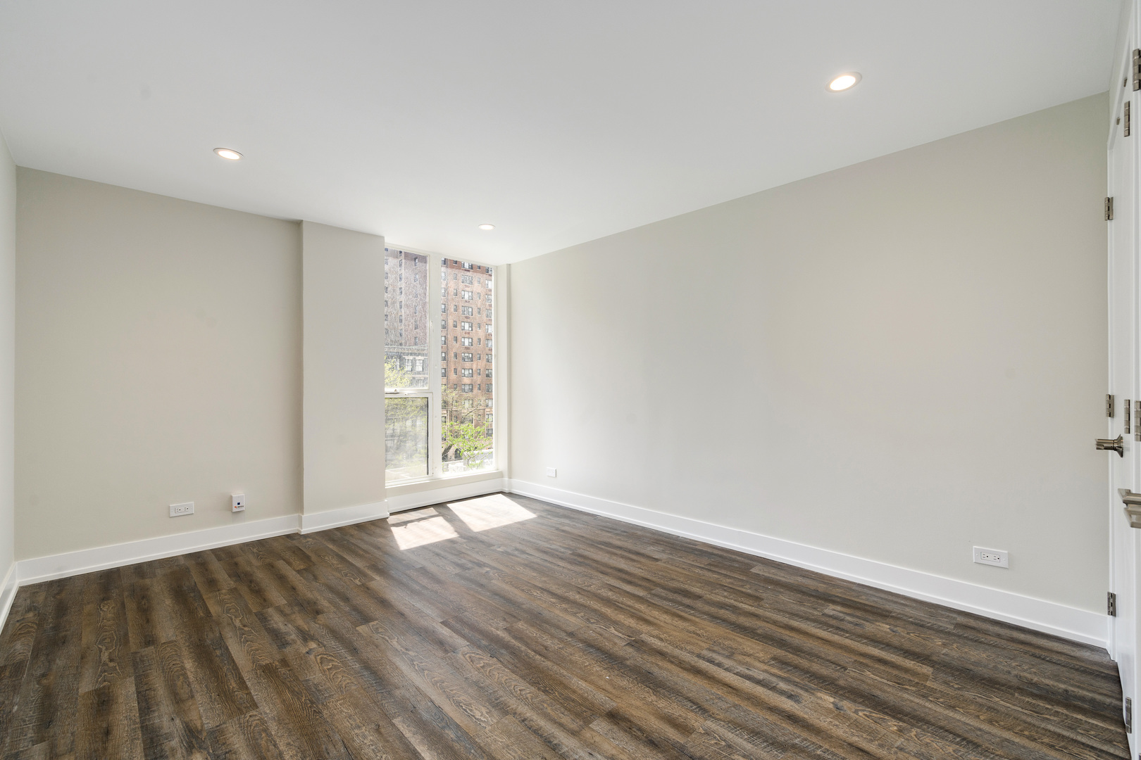 227 East Walton Place, Unit 3W Chicago, IL 60611 - Photo 10 of 15 a view of an empty room with wooden floor and a window