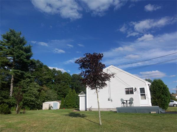 144 Morrison Road Taunton, MA 02718 - Photo 2 of 30 a view of a white house with a big yard and a large tree