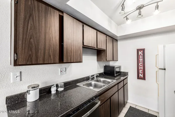 a kitchen with a sink a stove and cabinets