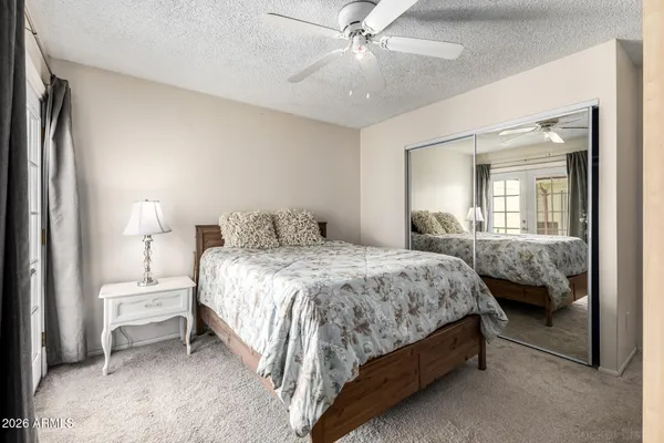 a bedroom with a bed and a large mirror