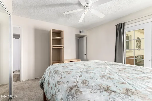 a bedroom with a large bed and a chandelier