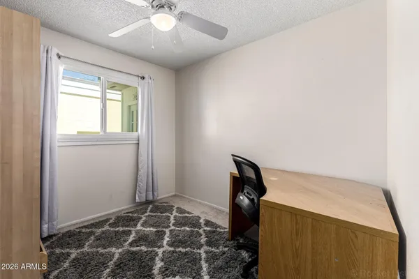 a view of a livingroom with wooden floor and a window