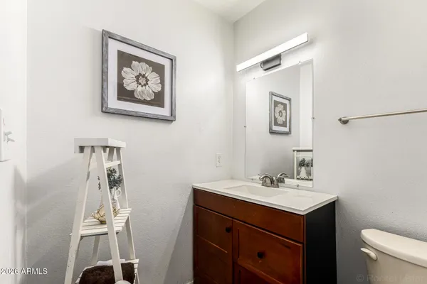 a bathroom with a sink a toilet and mirror