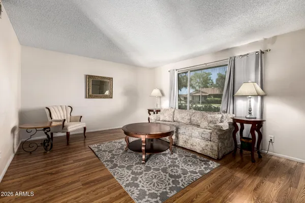 a living room with furniture and a wooden floor
