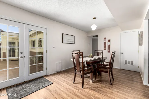 a view of a dining room with furniture and wooden floor