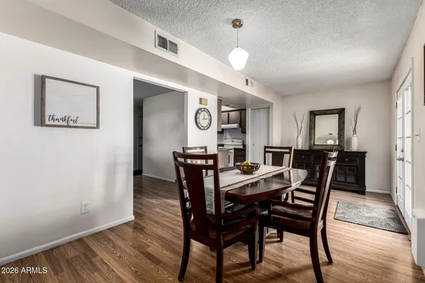 a view of a dining room with furniture and wooden floor