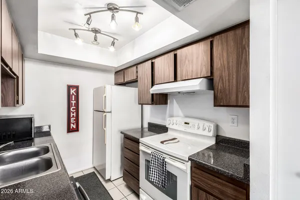 a utility room with dryer washer and a view of living room