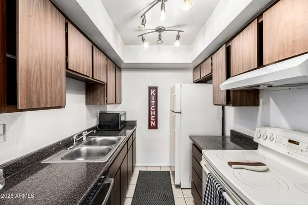 a kitchen with a sink a stove and cabinets