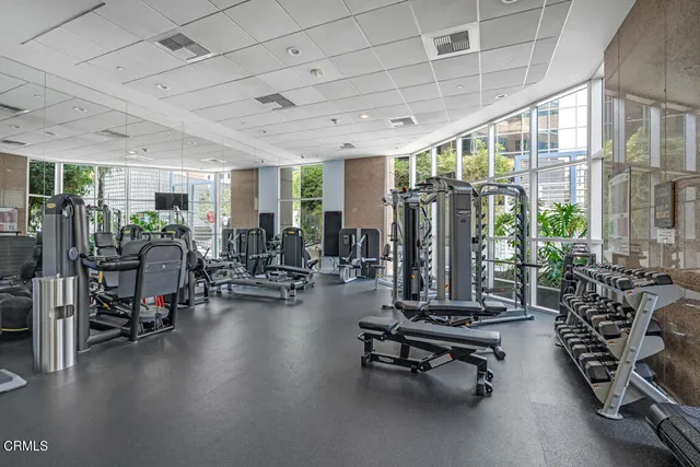 a living room with patio furniture and a large window