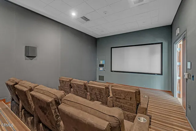a media room with lots of chairs and a projector screen