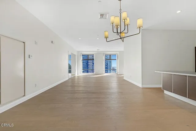a view of a kitchen with a sink and chandelier