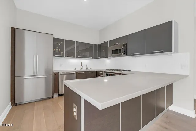 a kitchen with stainless steel appliances granite countertop a stove and a sink