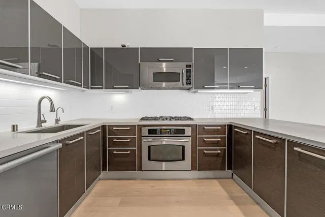 a kitchen with cabinets appliances and a sink