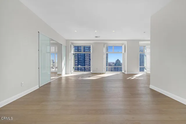 a view of a room with wooden floor and a window