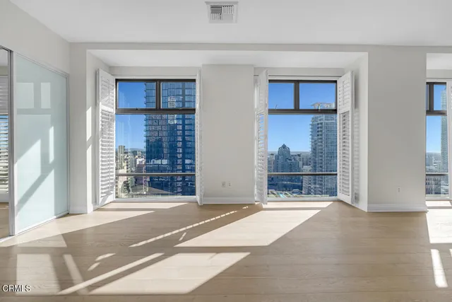 a view of empty room with wooden floor